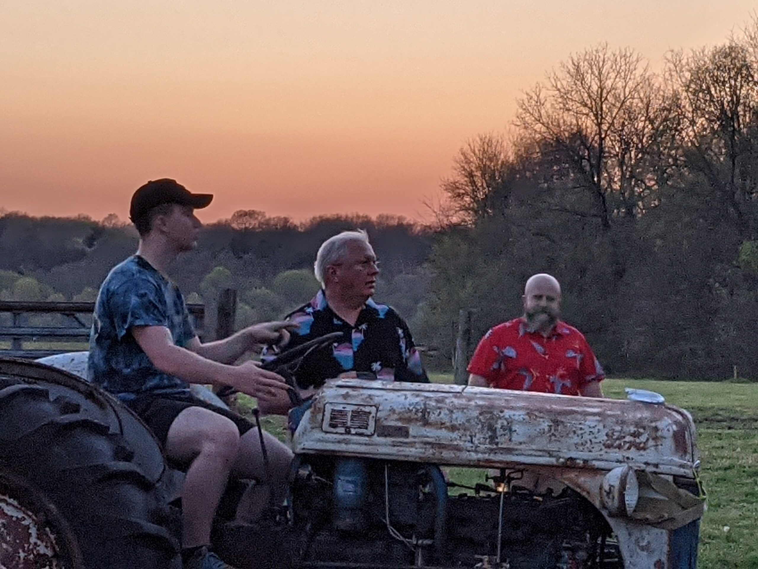 Three men at the tractor at Faith Family Farms